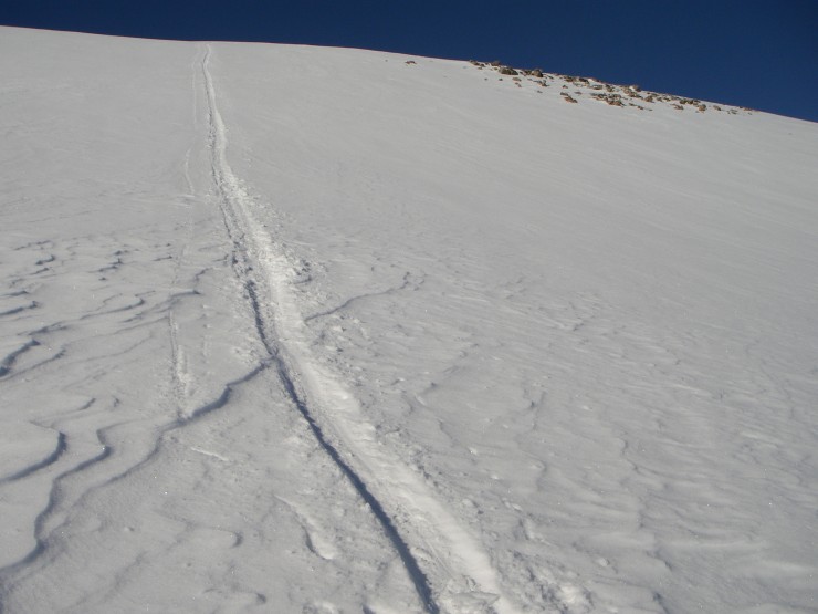 The snow was quite variable. Softening in the heat of the sun, as shown by my bum slide track. 