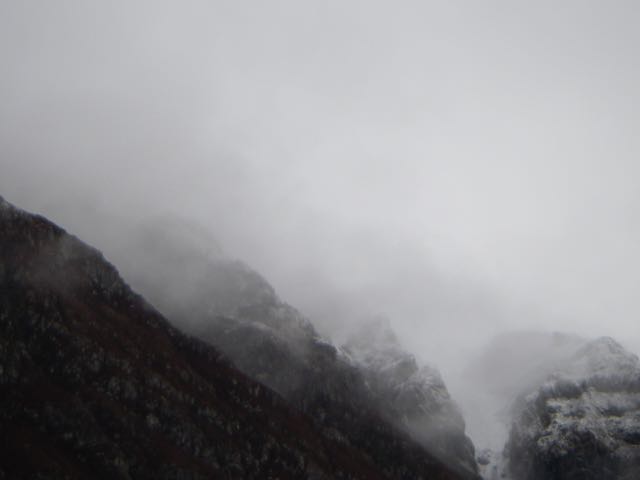 The turret-like buttresses of   the Aonach Eagach Ridge atmospheric looking in the cloud 