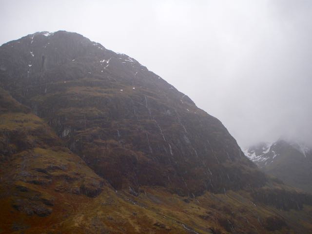 The north side of Aonach Dubh with Osssians cave visible. Note the water flowing down the face.